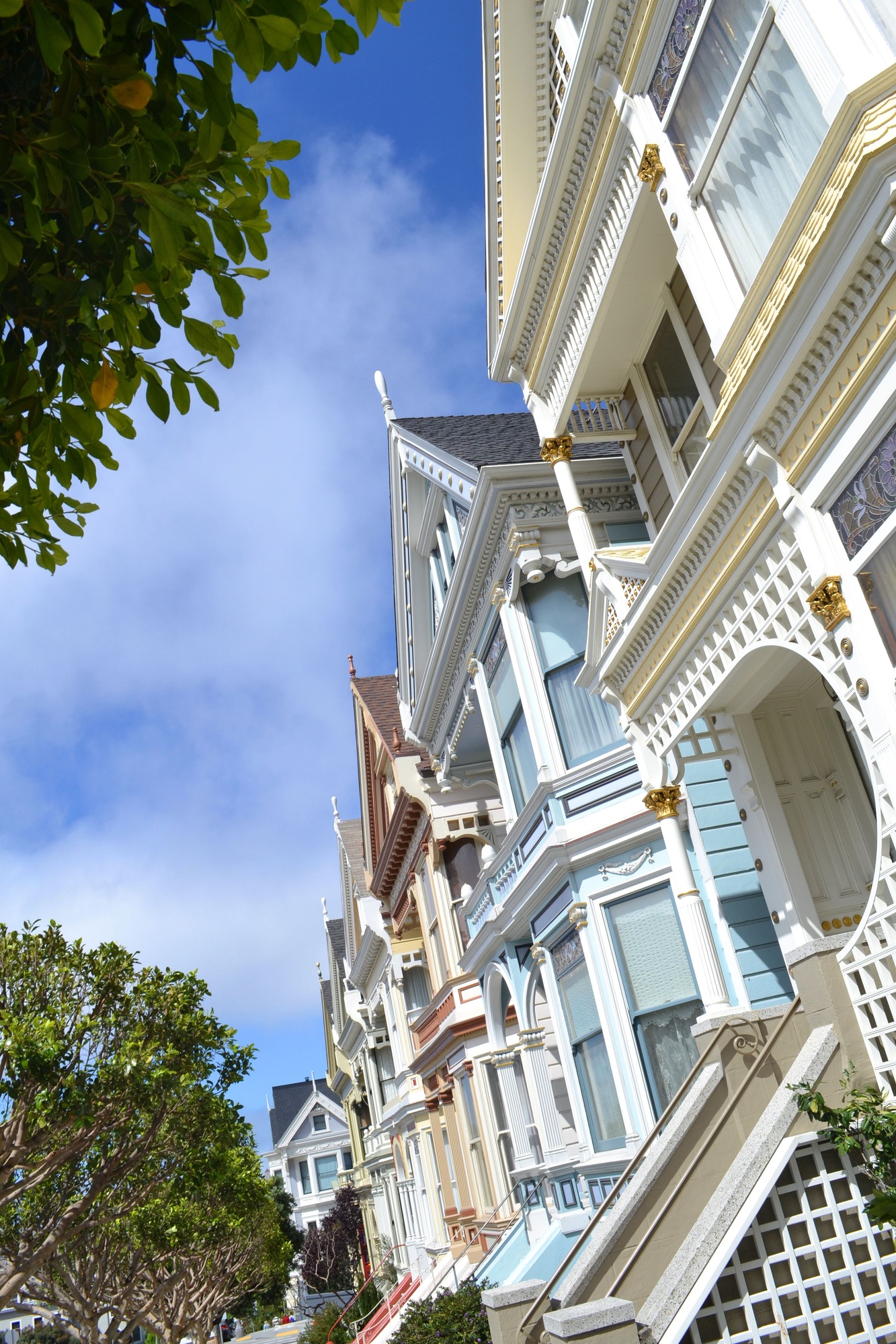 The iconic pastel Painted Ladies Victorian homes in neighborhood San Francisco, CA angle perspective
